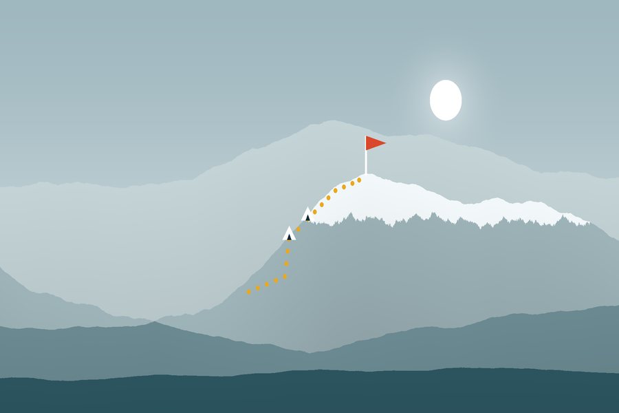 Misty mountain ridges with a trail and two camps